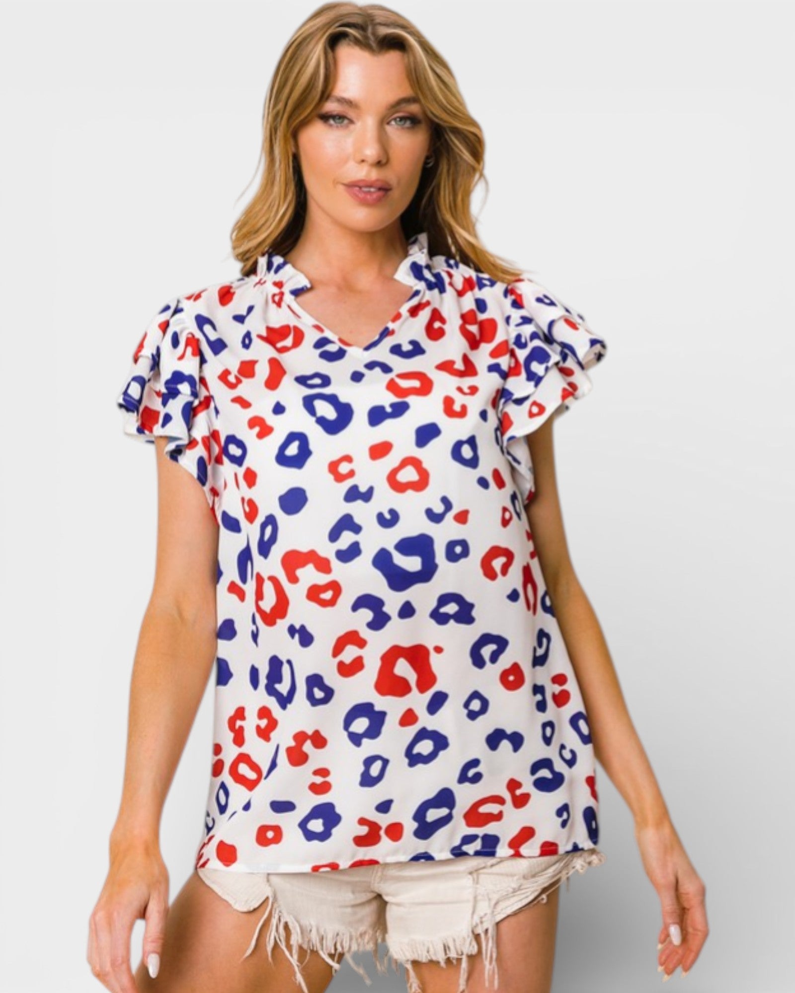 Woman wearing a colorful leopard print top on a white background