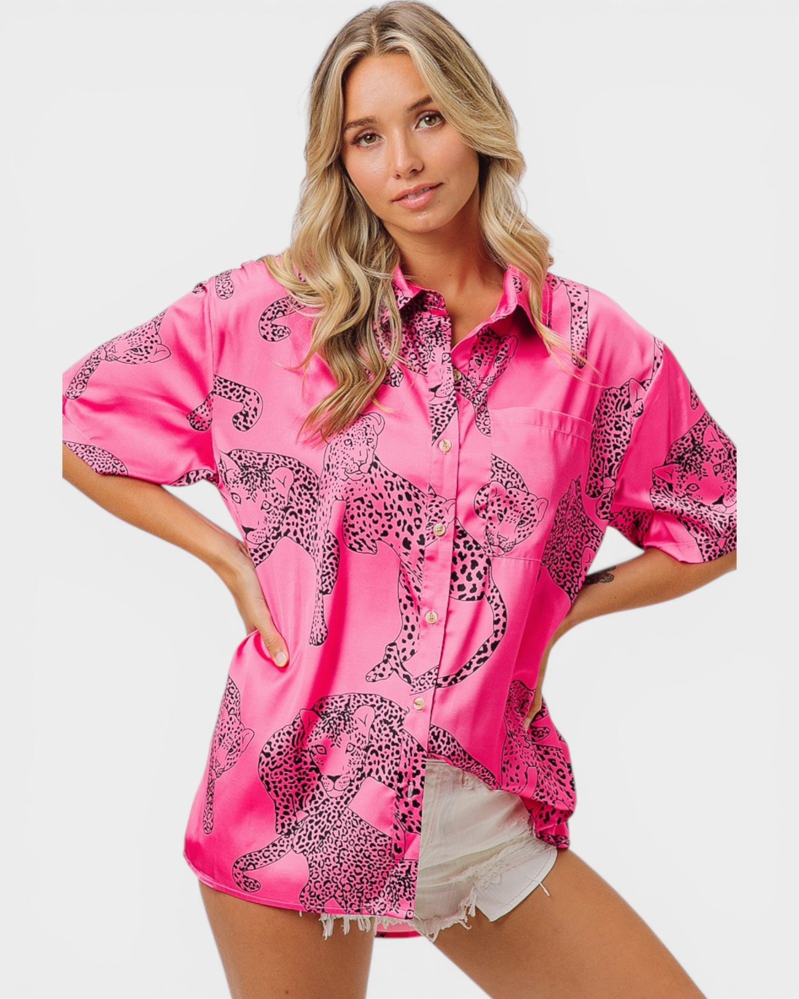 Woman wearing a pink shirt with leopard print design on a white background