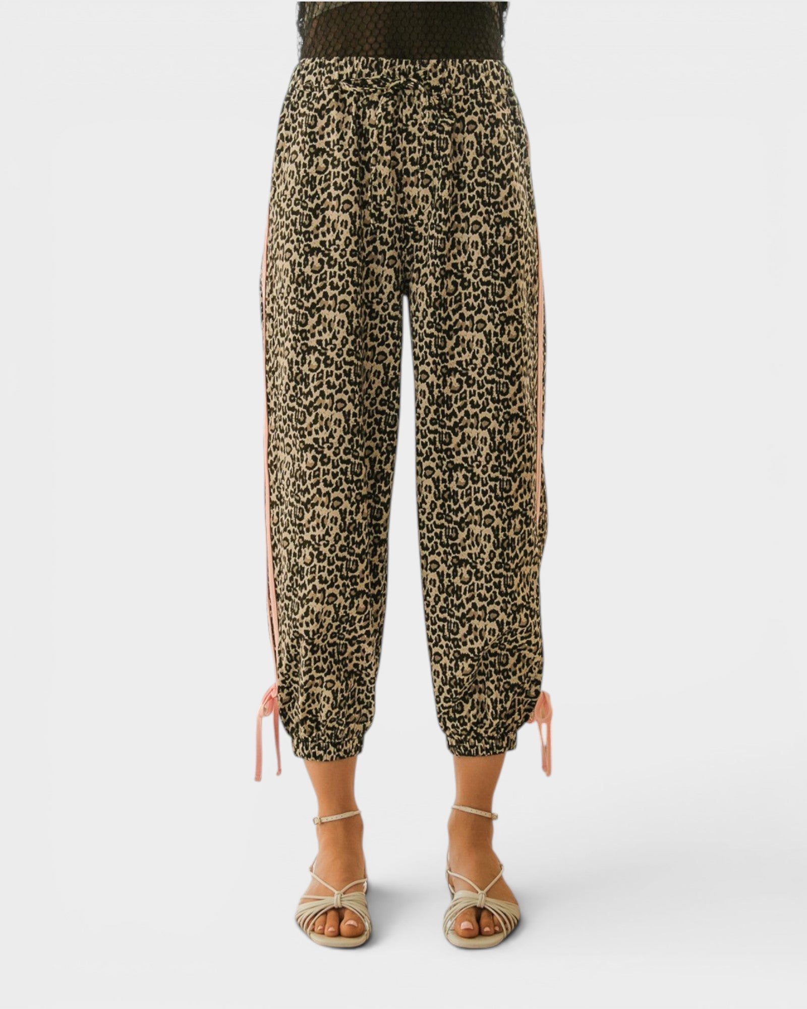 Leopard print pants worn by a person on a white background