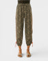 Leopard print pants worn by a person on a white background