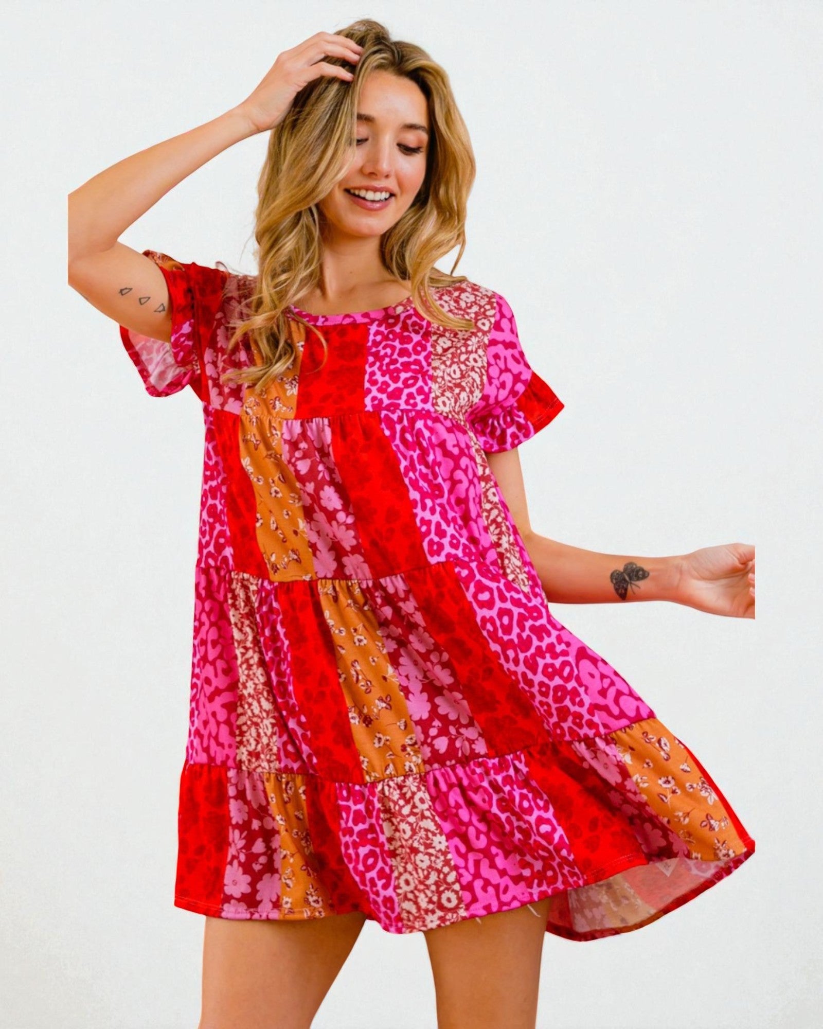 Woman wearing a colorful patterned dress on a white background