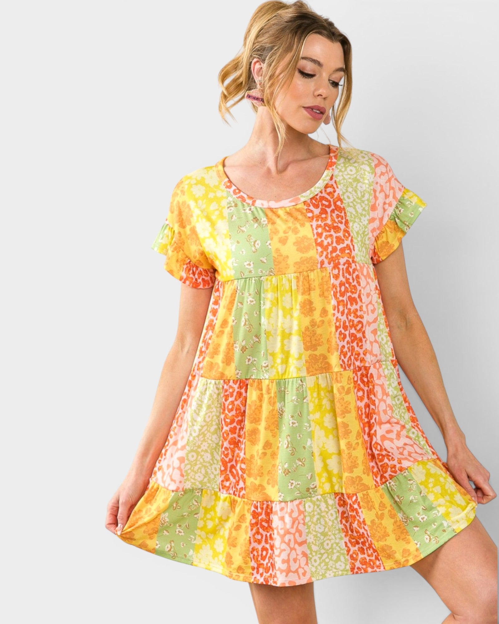 Woman wearing a colorful patterned dress on a white background