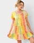 Woman wearing a colorful patterned dress on a white background