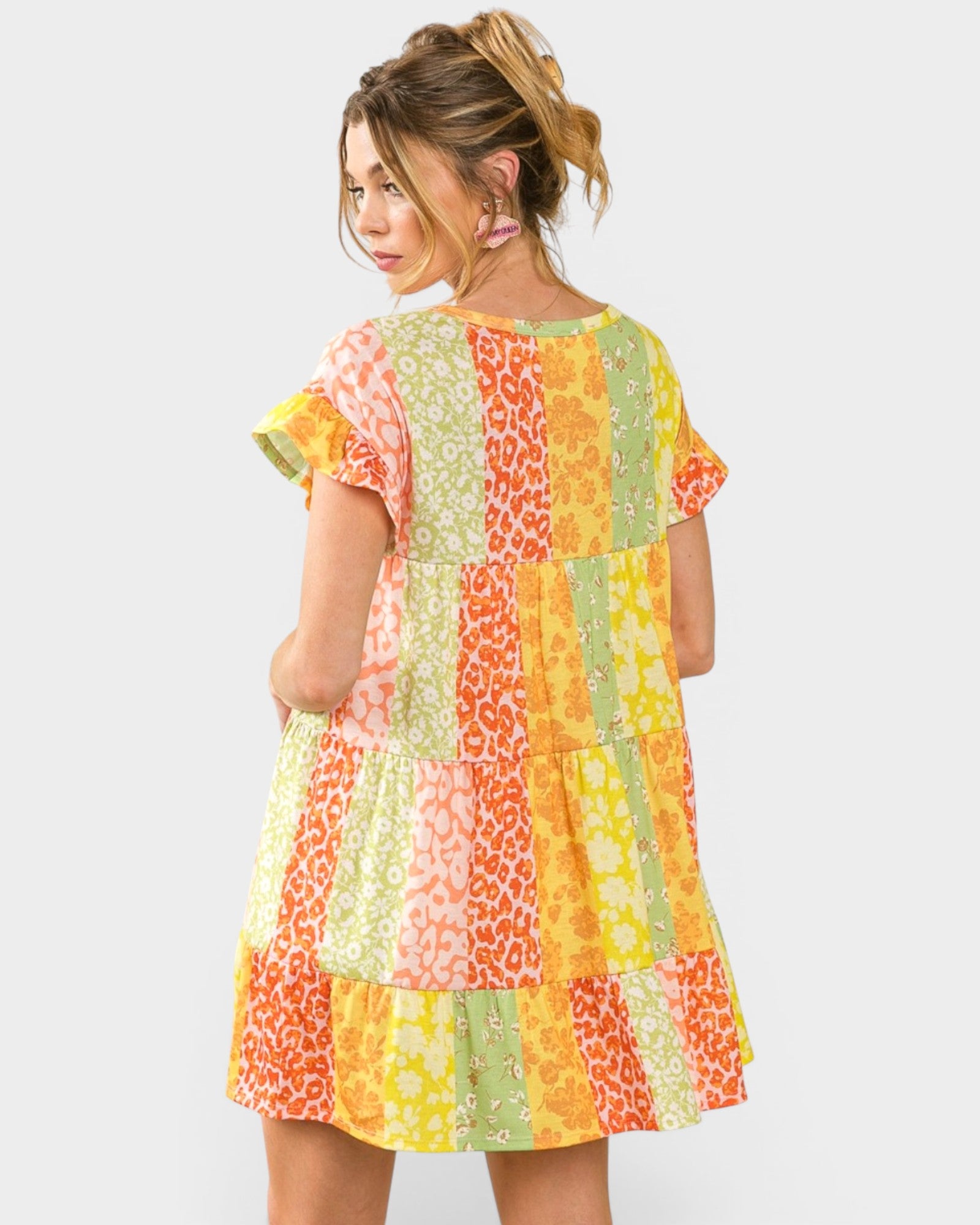 Woman wearing a colorful patchwork dress on a white background