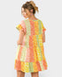 Woman wearing a colorful patchwork dress on a white background