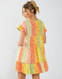 Woman wearing a colorful patchwork dress on a white background