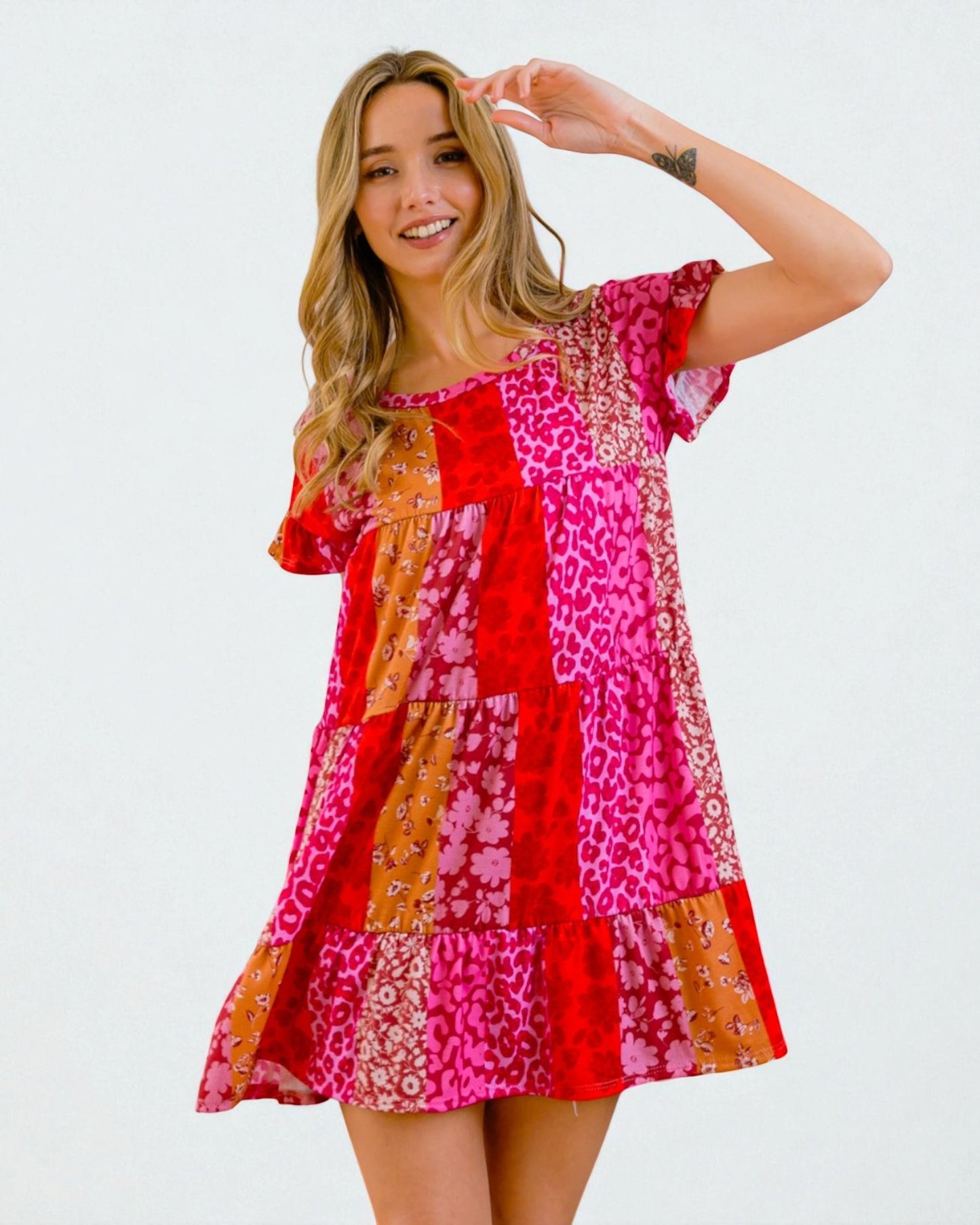 Woman wearing a colorful patterned dress on a white background