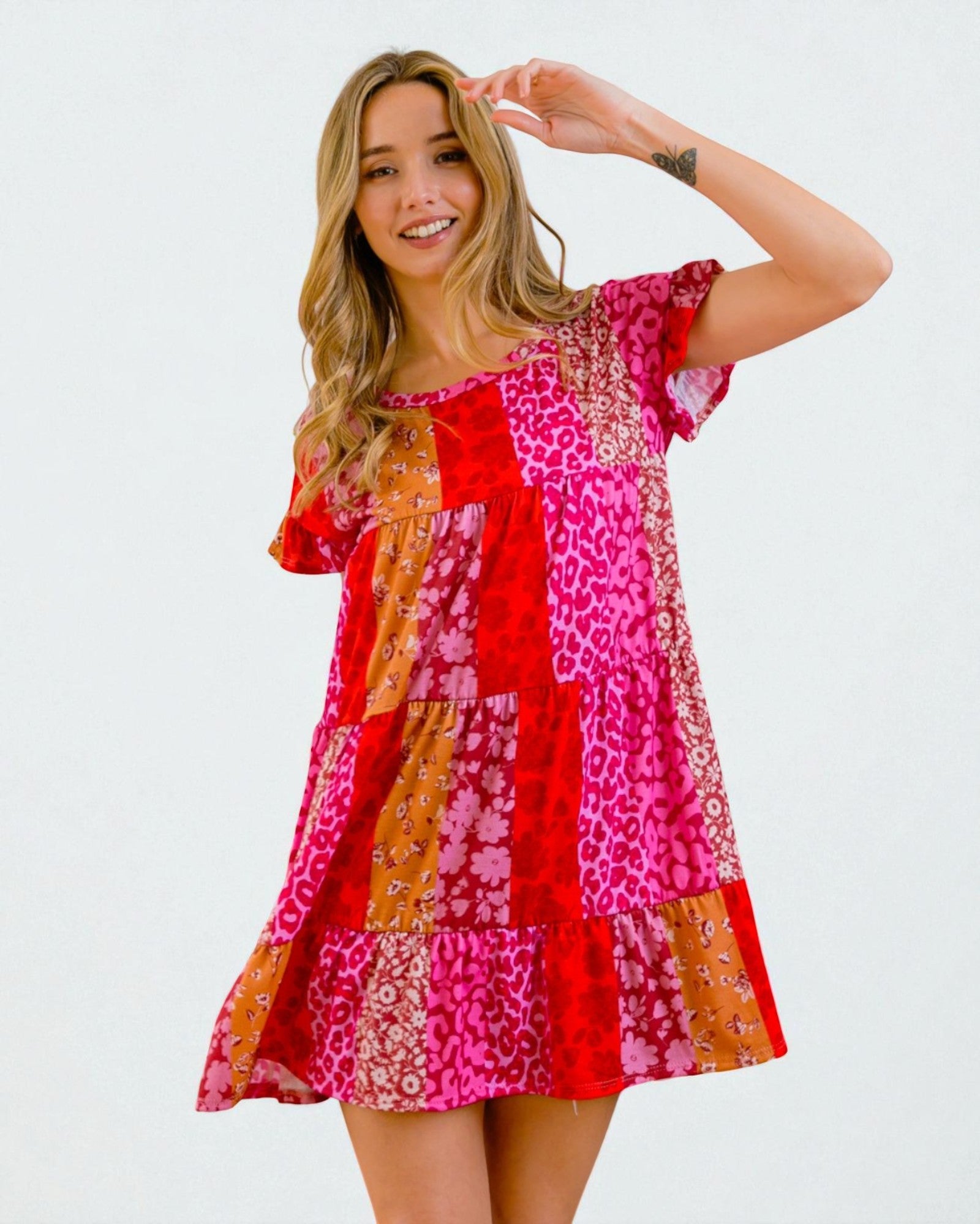 Woman wearing a colorful patterned dress on a white background