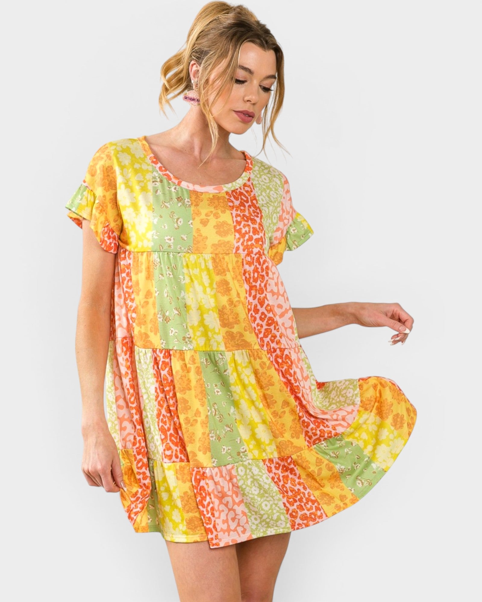 Woman wearing a colorful patterned dress on a white background