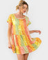 Woman wearing a colorful patterned dress on a white background