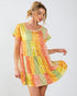 Woman wearing a colorful patterned dress on a white background