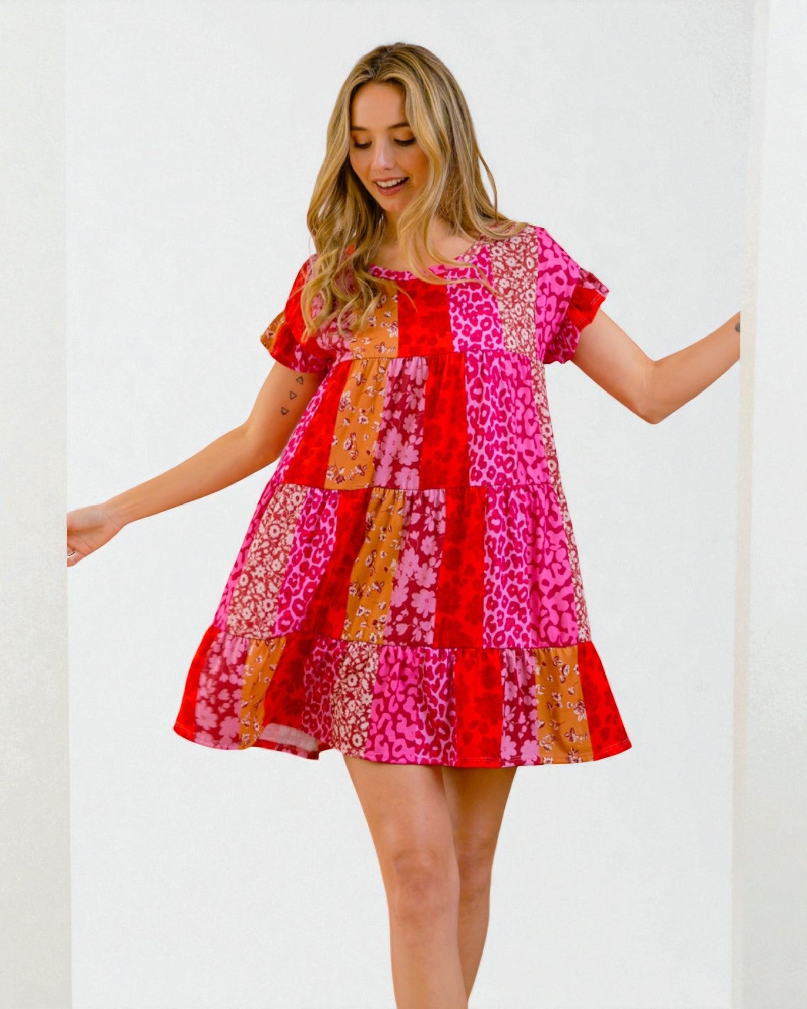 Woman wearing a colorful patchwork dress on a white background