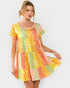 Woman wearing a colorful patchwork dress on a white background
