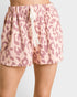 Pink leopard print shorts worn by a person on a light gray background