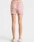 Pink leopard print shorts worn by a person on a white background