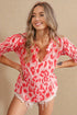 Woman wearing a red and white patterned cover-up against a beige background