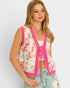 Woman wearing a sleeveless patterned vest with pink accents on a plain background