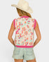 Person wearing a colorful leopard print vest and light denim shorts on a white background