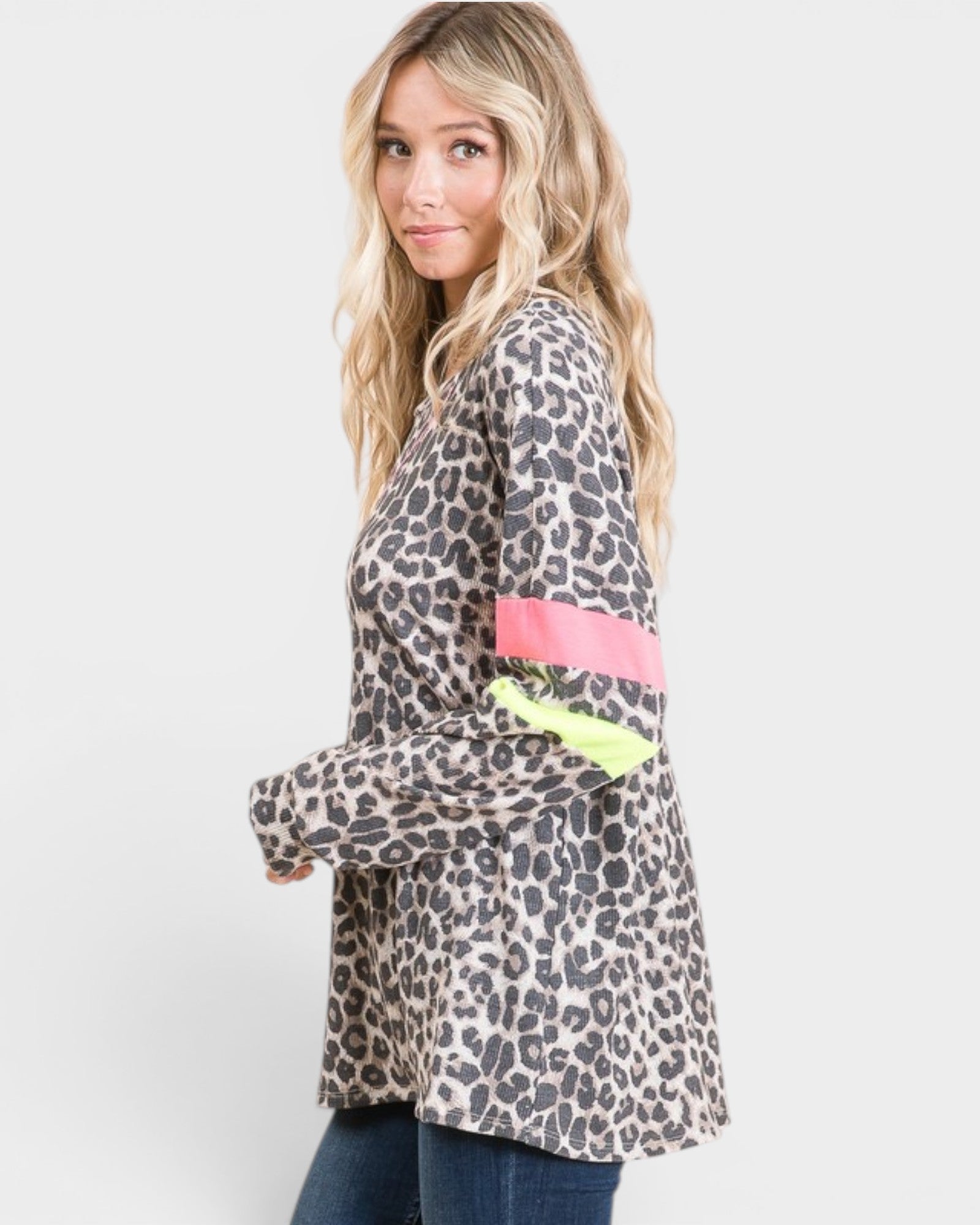 Woman wearing a leopard print jacket with colorful accents on a white background