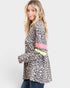 Woman wearing a leopard print jacket with colorful accents on a white background