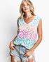 A woman modeling a sleeveless V-neck top with a pastel leopard print pattern in light blue, pink, peach, and white, paired with frayed denim shorts against a plain white background.