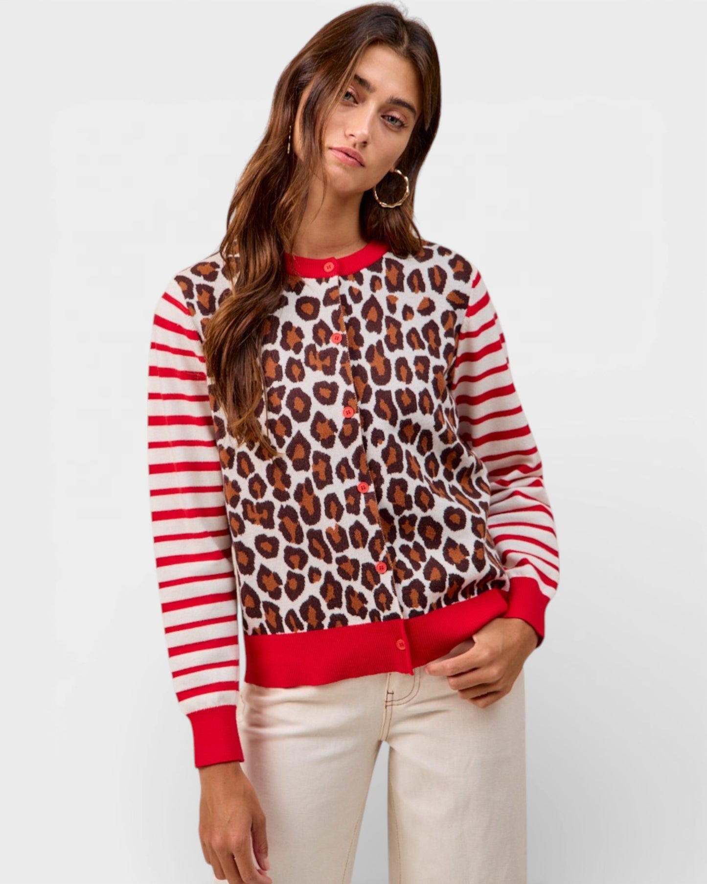 Woman wearing a leopard print and red striped sweater on a white background