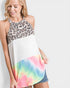 Woman wearing a halter top with leopard print, white, and tie-dye design on a plain background
