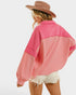 Person wearing a pink color-blocked shirt with a white background
