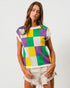 Woman wearing a colorful checkered shirt with a plain background
