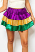 Colorful tiered skirt with purple, gold, and green on a plain background
