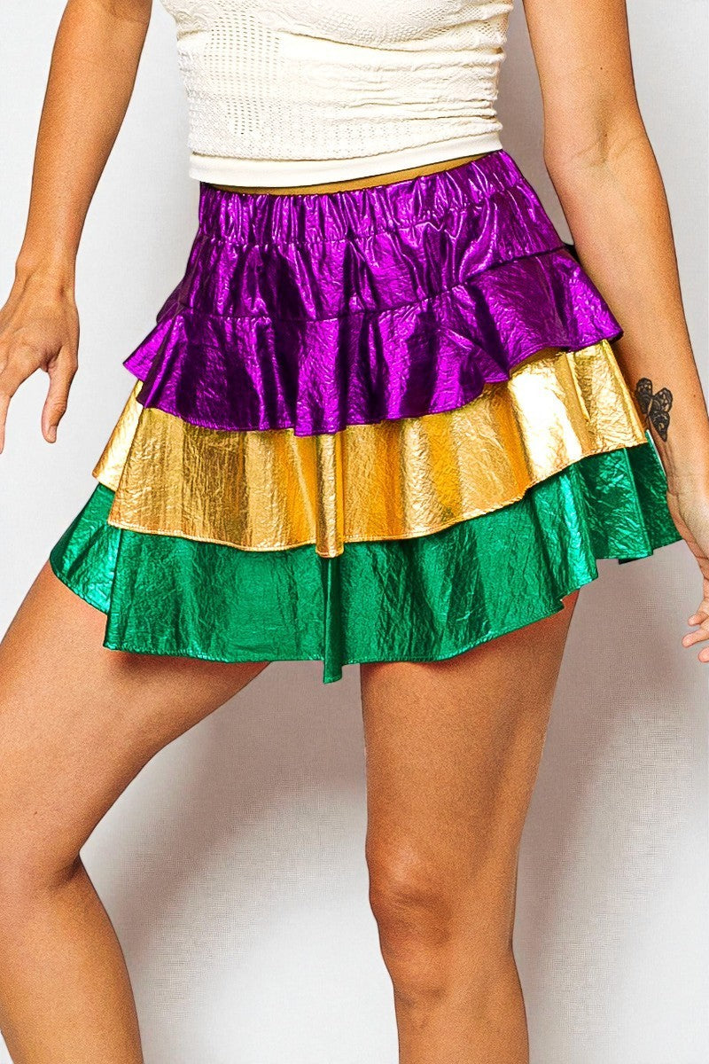 Multicolored ruffled skirt worn by a person on a plain background