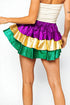 Colorful tiered skirt with a white top on a plain background