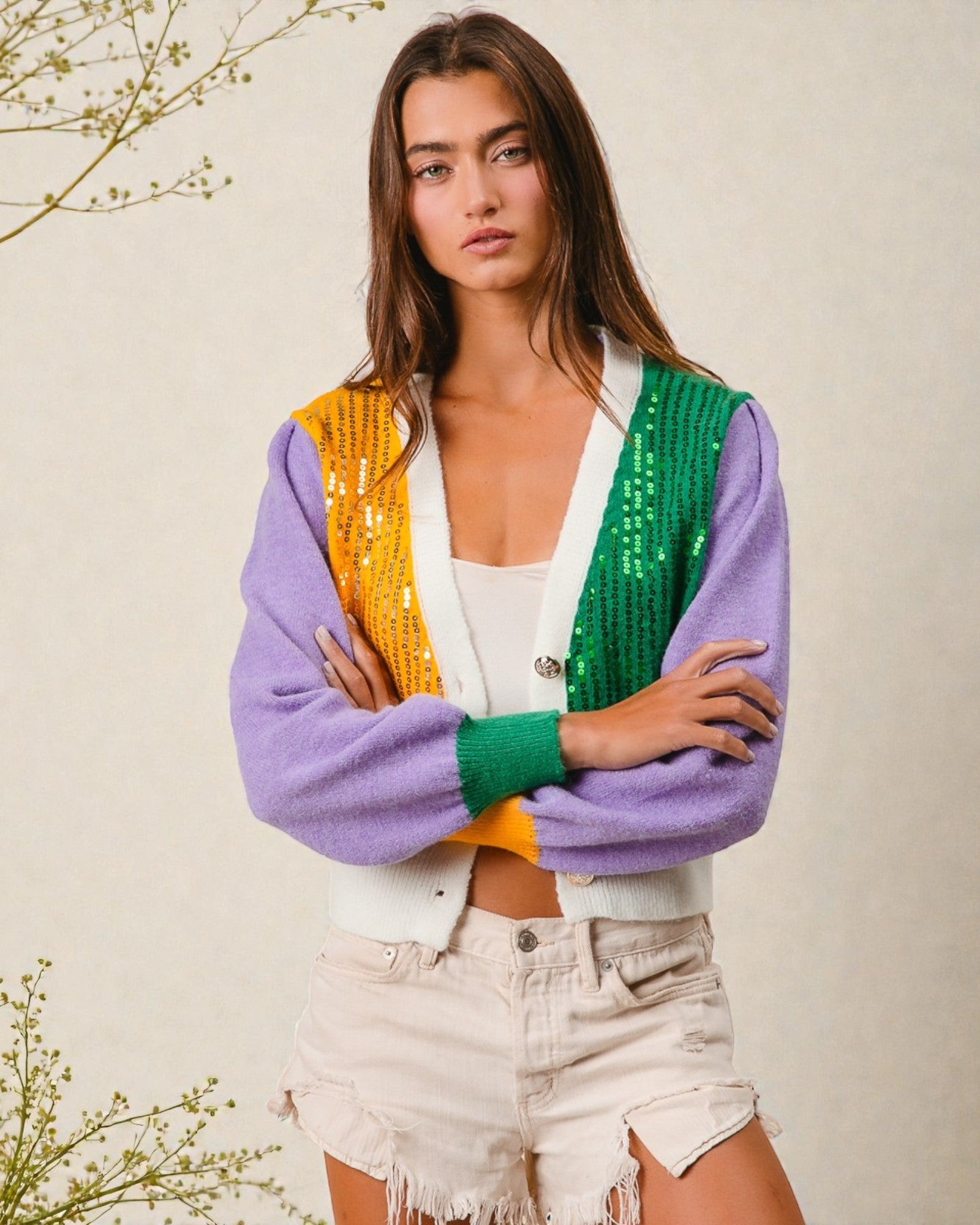 Woman wearing a colorful cardigan with a neutral background