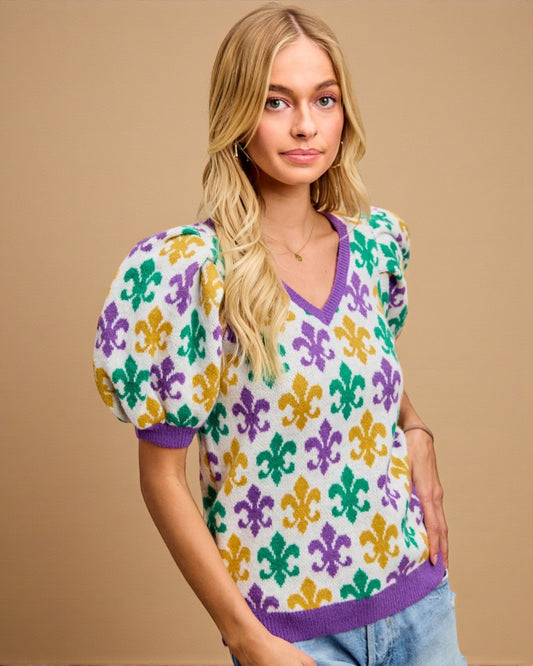 Woman wearing a colorful patterned shirt against a beige background