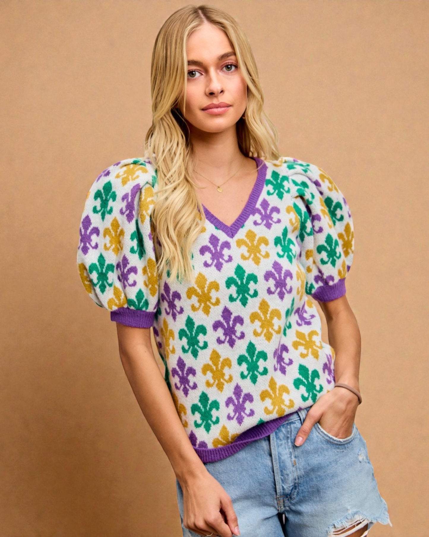 Woman wearing a colorful patterned shirt with a brown background