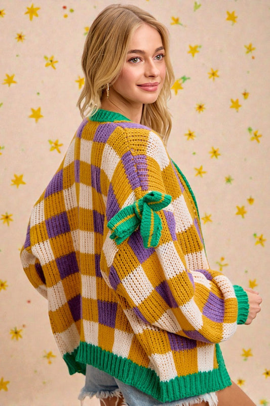 Woman wearing a colorful striped sweater with a patterned background