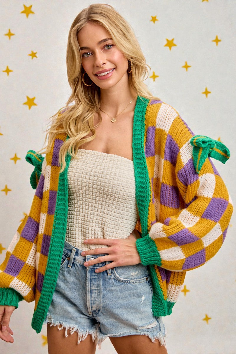 Woman wearing a colorful checkered cardigan with a star-patterned background