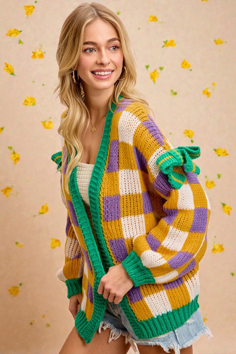 Woman wearing a colorful knitted cardigan with a patterned background