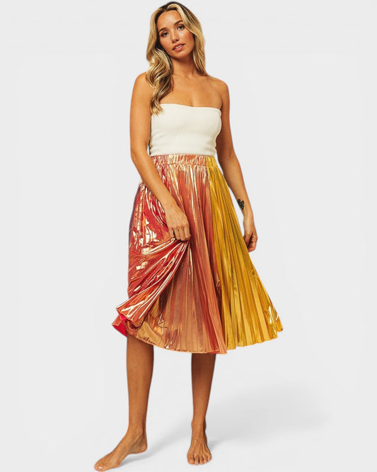Woman wearing a colorful pleated skirt on a white background
