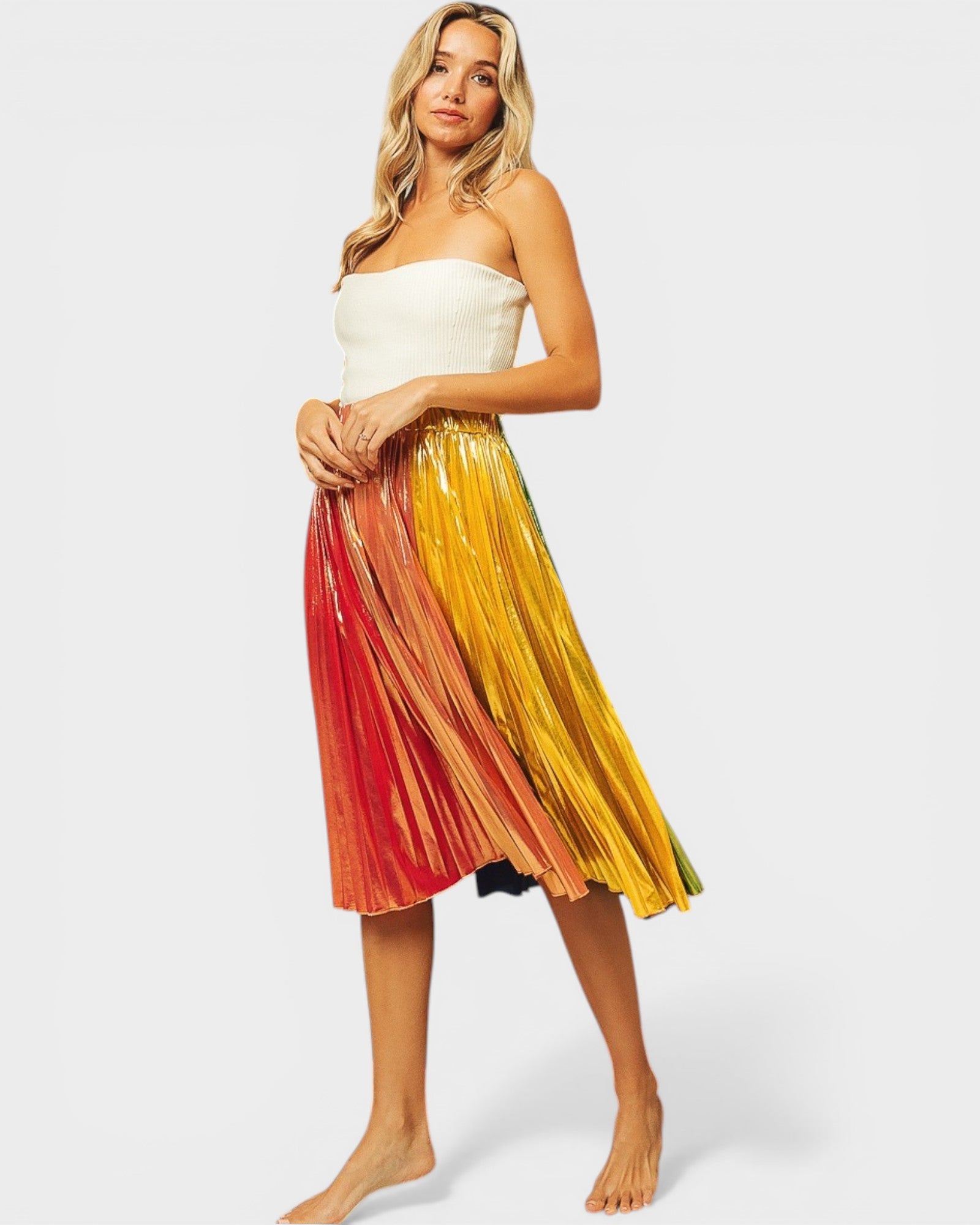 Woman wearing a strapless top and pleated skirt with a gradient of colors on a white background