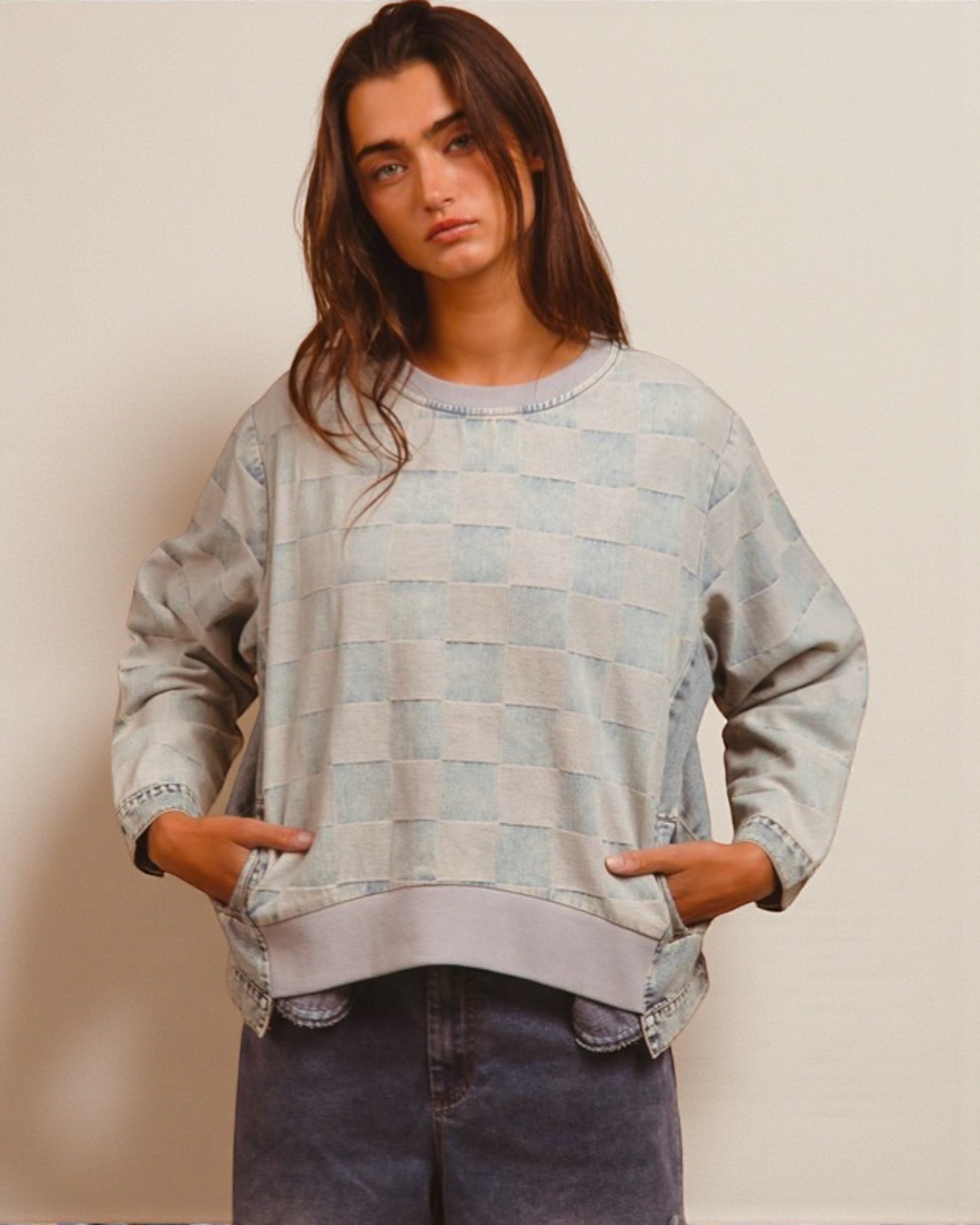 Person wearing a patterned sweater with a neutral background