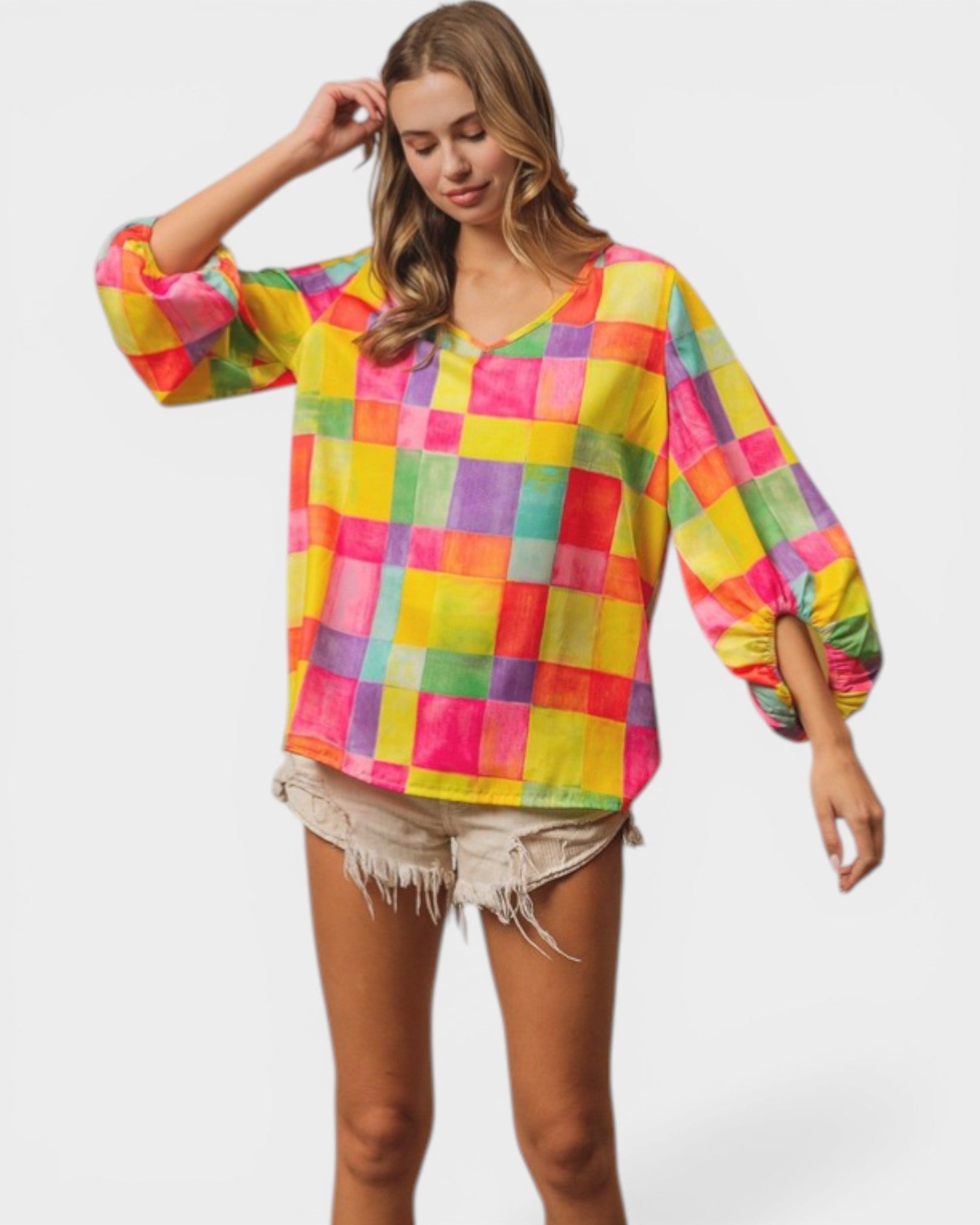 Woman wearing a colorful checkered blouse on a white background