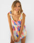 Woman wearing a colorful geometric patterned dress on a white background