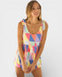 Woman wearing a colorful geometric patterned dress on a white background