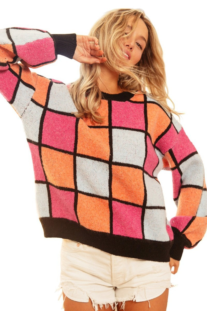 Person wearing a colorful checkered sweater with a white background