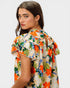 Woman wearing a colorful floral dress on a white background