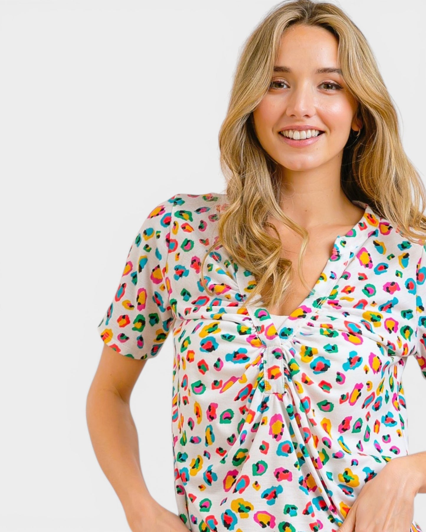 Woman wearing a colorful patterned dress on a white background