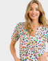 Woman wearing a colorful patterned dress on a white background