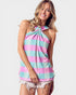 Woman wearing a colorful striped halter top on a plain background