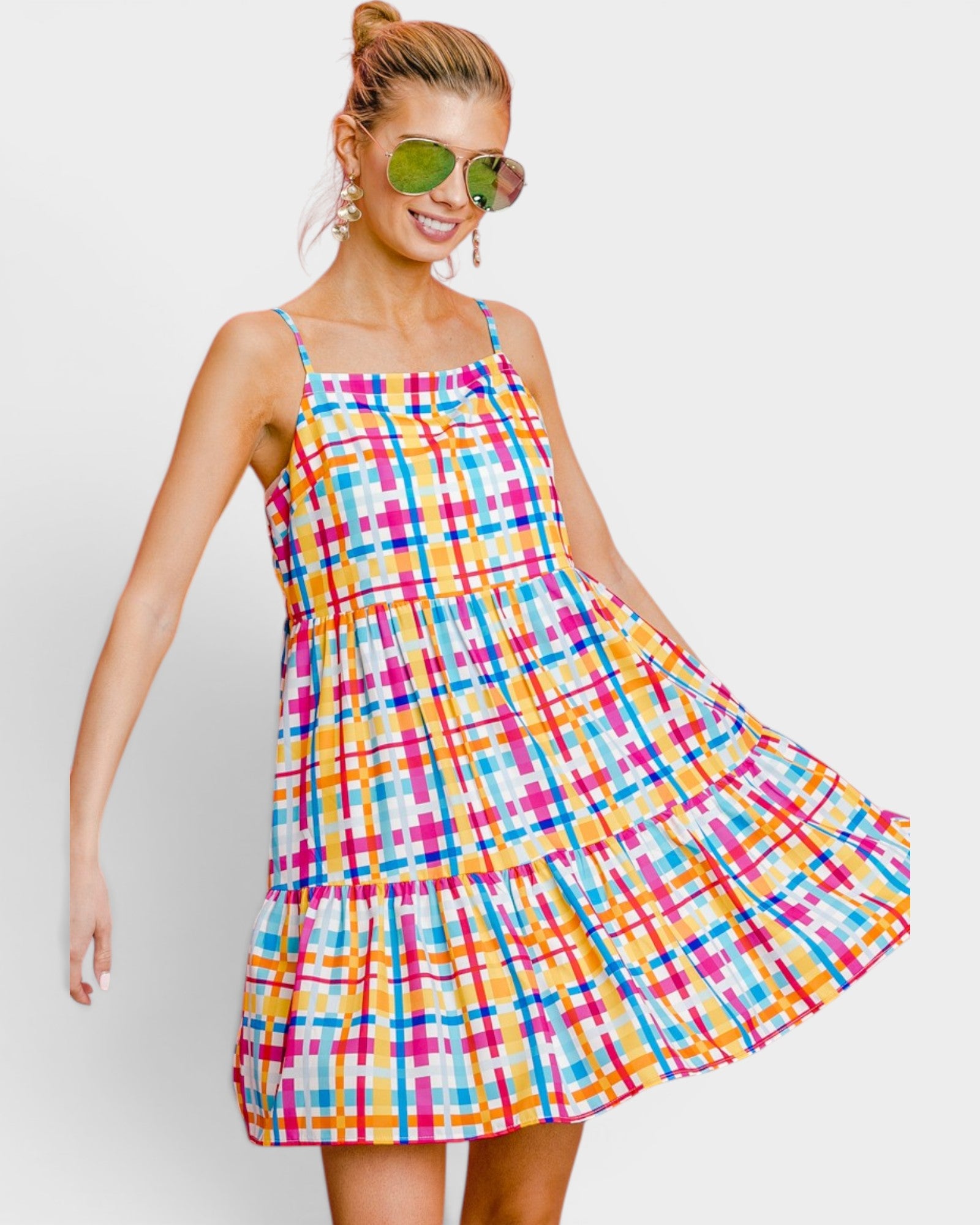 Woman wearing a colorful plaid dress on a white background